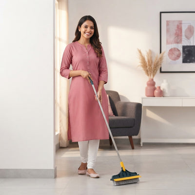 A woman holding a two-in-one floor scrub cleaning brush wiper in a bright, modern living space.